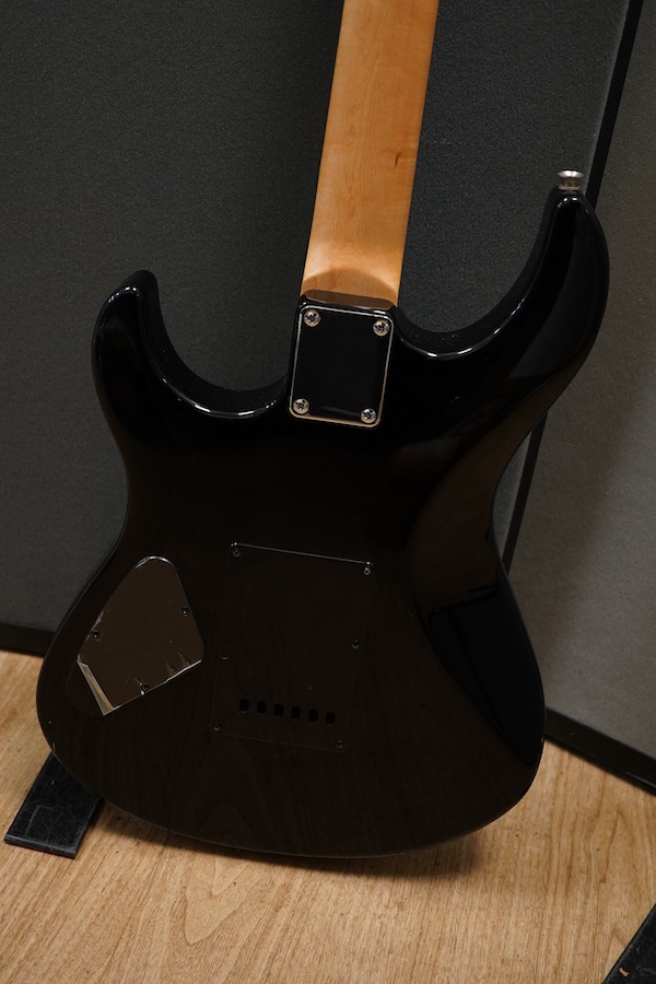 A Yamaha ERG121 electric guitar in black finish, with a soft gig case